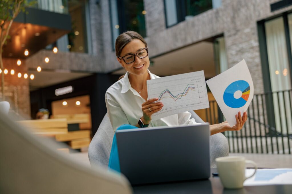Smiling,Female,Manager,Showing,Documents,To,Colleagues,During,Online,Meeting