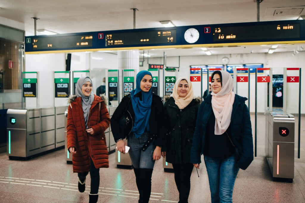 Happy,Multi ethnic,Muslim,Friends,Walking,At,Subway,Station