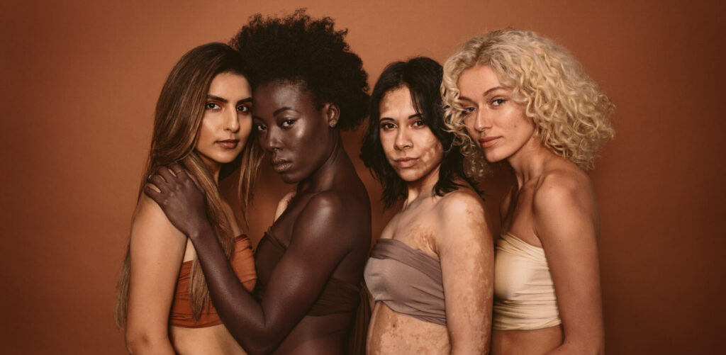 Group,Of,Diverse,Women,Standing,Together,Against,Brown,Background.,Multi