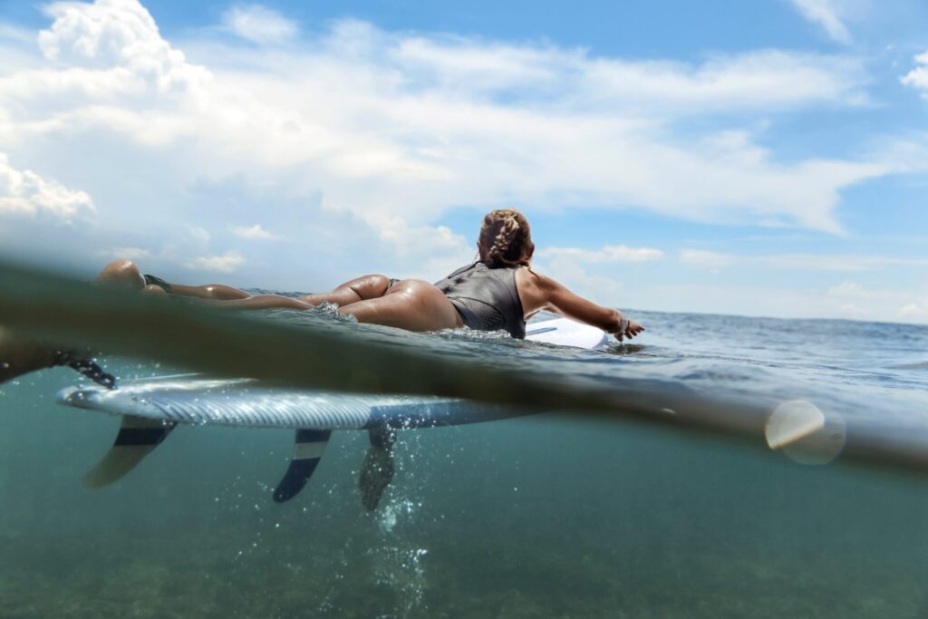 Woman,Lying,On,Surfboard,On,The,Sea