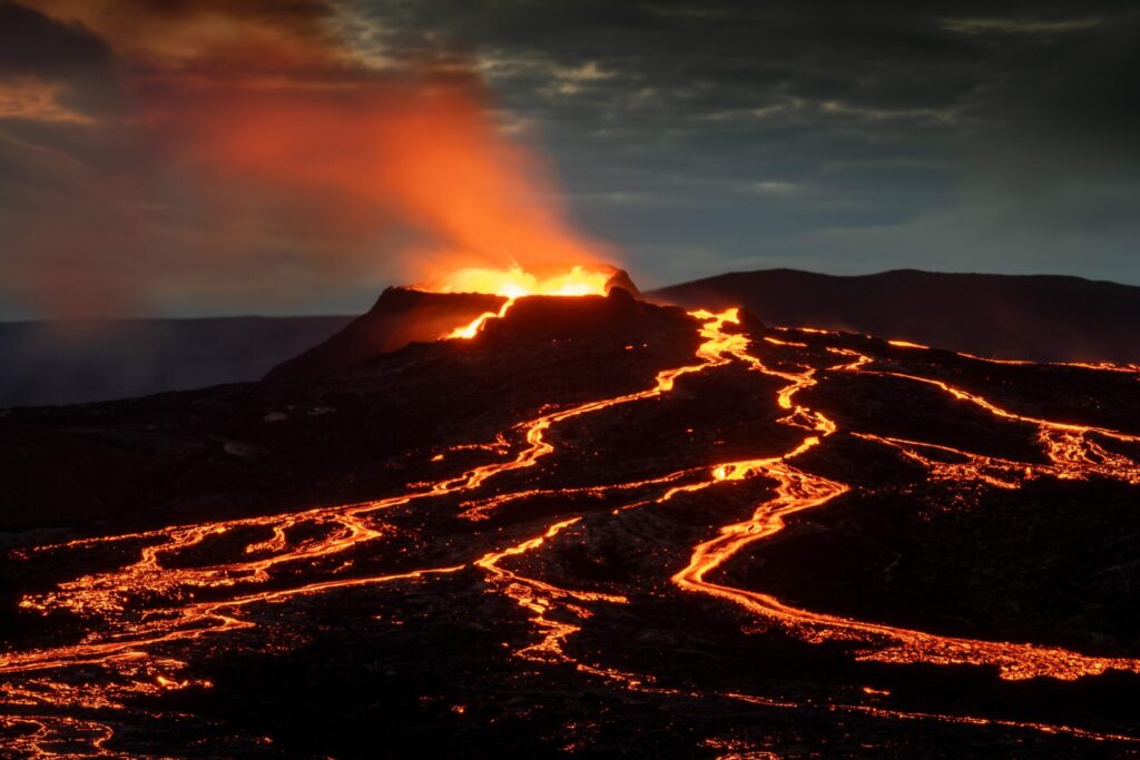 Lava,Spurting,Out,Of,Crater,And,Reddish,Illuminated,Smoke,Cloud,