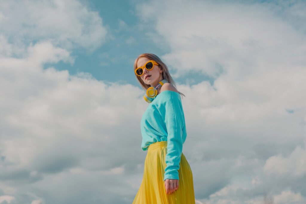 Fashionable,Woman,Wearing,Sunglasses,And,Standing,Under,Cloudy,Sky