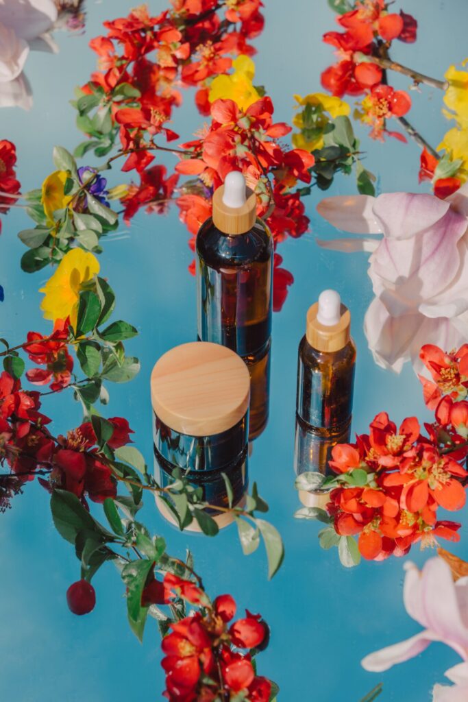 Cosmetic,Jar,And,Bottle,With,Blossom,Flowers,Petals,On,Mirror