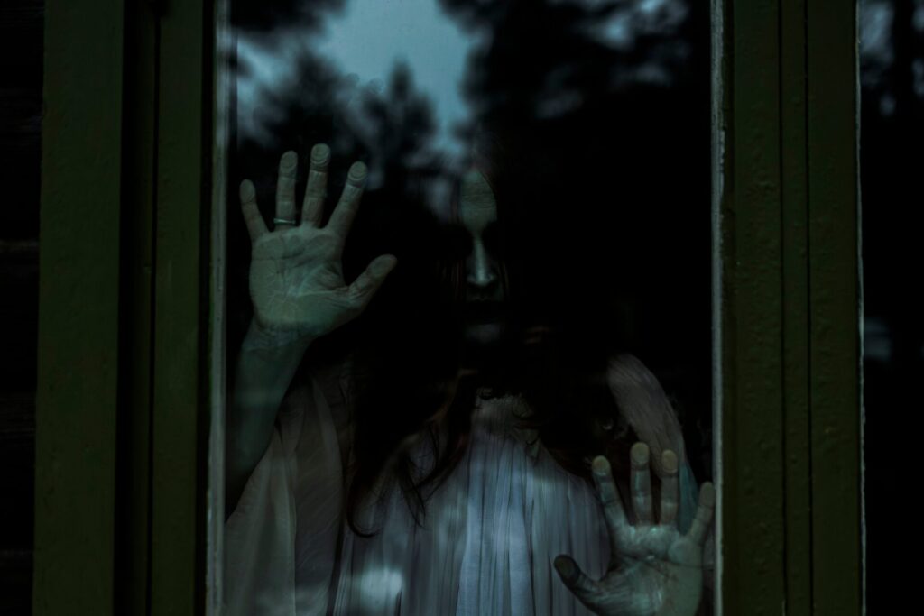 Spooky,Ghost,Looking,Through,Glass,Window,Of,Haunted,Cabin