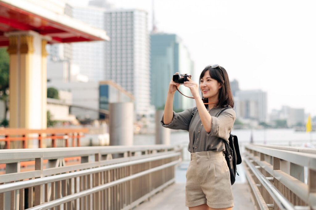 Young,Asian,Woman,Backpack,Traveler,Using,A,Camera,In,Express