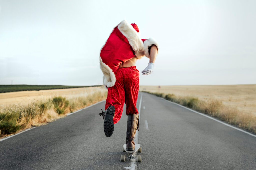 Santa,Claus,Riding,On,Longboard,On,Country,Road