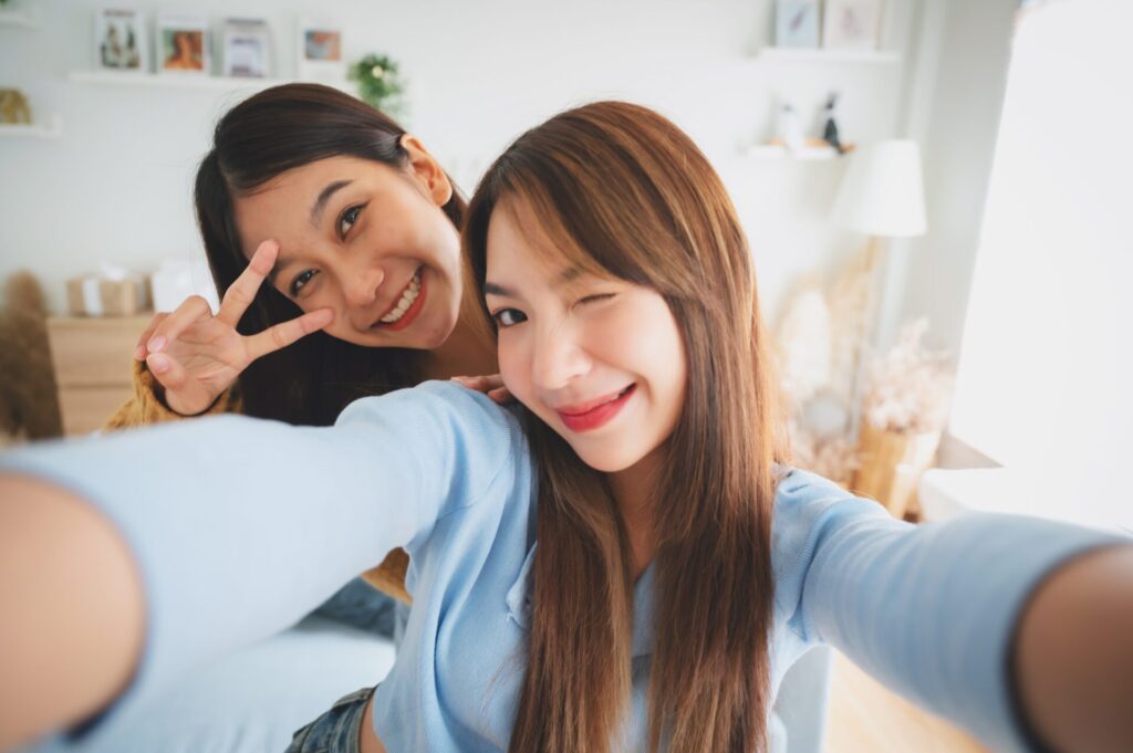 Two,Asian,Young,Women,Happy,Smiling,And,Taking,Selfie,In