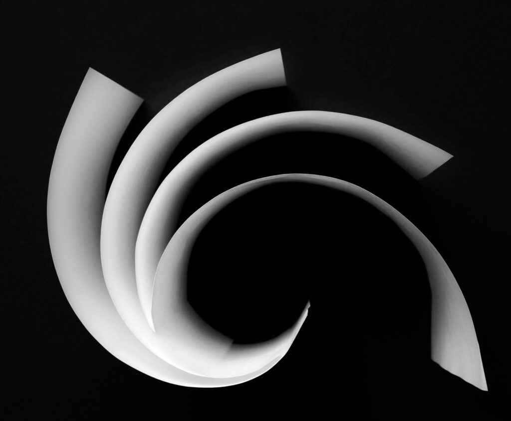 Abstract,White,Curved,Paper,Isolated,On,Black,Background