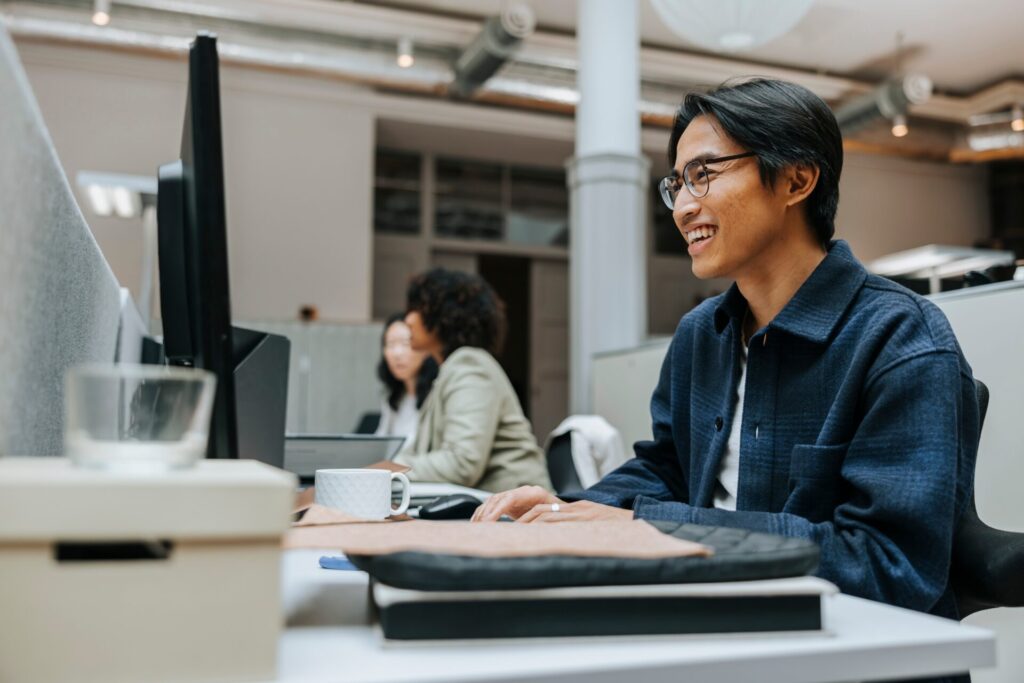 Happy,Businessman,Working,On,Computer,While,Sitting,In,Office