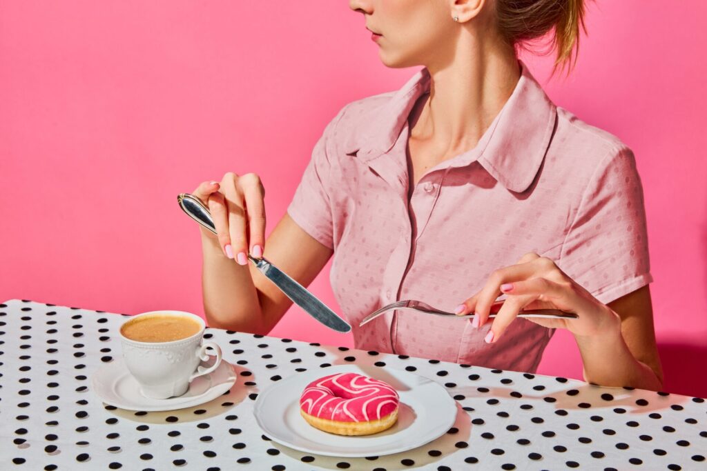 Young,Woman,Having,Delicious,Breakfast,With,Donut,And,Coffee,Over