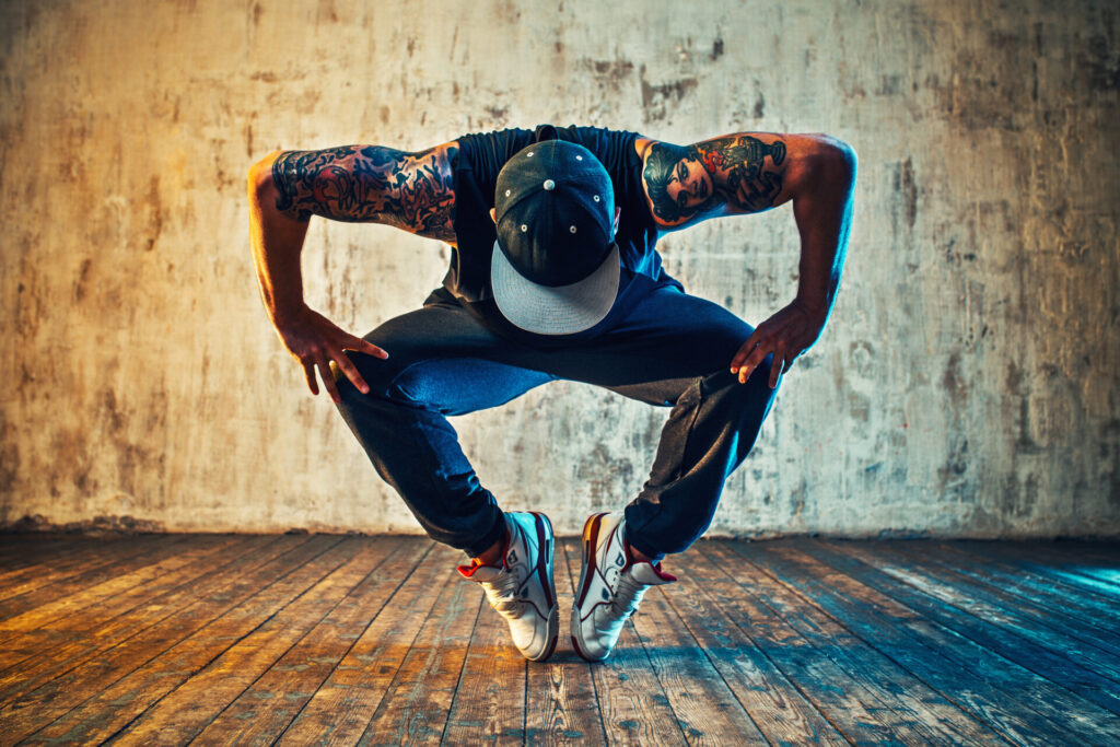 Young,Man,Break,Dancing,On,Wall,Background.,Blue,And,Yellow