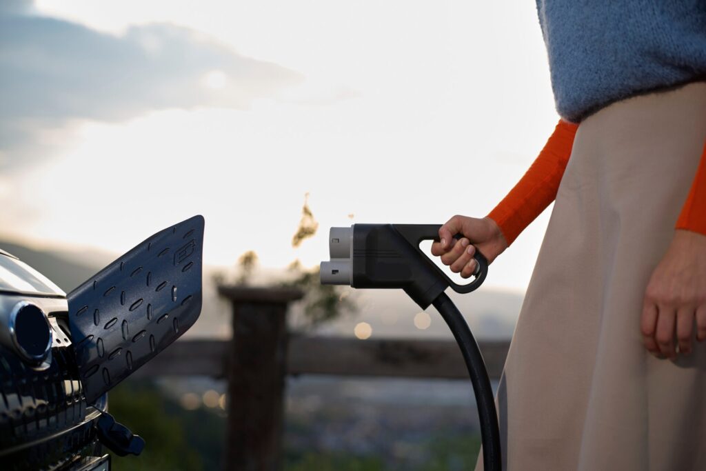 Close up,Of,A,Person's,Hand,Plugging,An,Electric,Vehicle,Charger