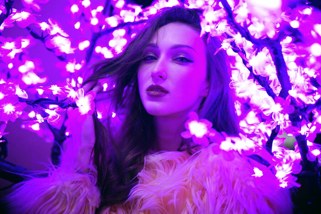 Sexy,Young,Beautiful,Woman,Posing,Near,Neon,Sakura,Tree,Lights