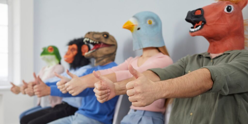 Crazy,Eccentric,Young,People,In,Trendy,Animal,Masks,Sitting,In
